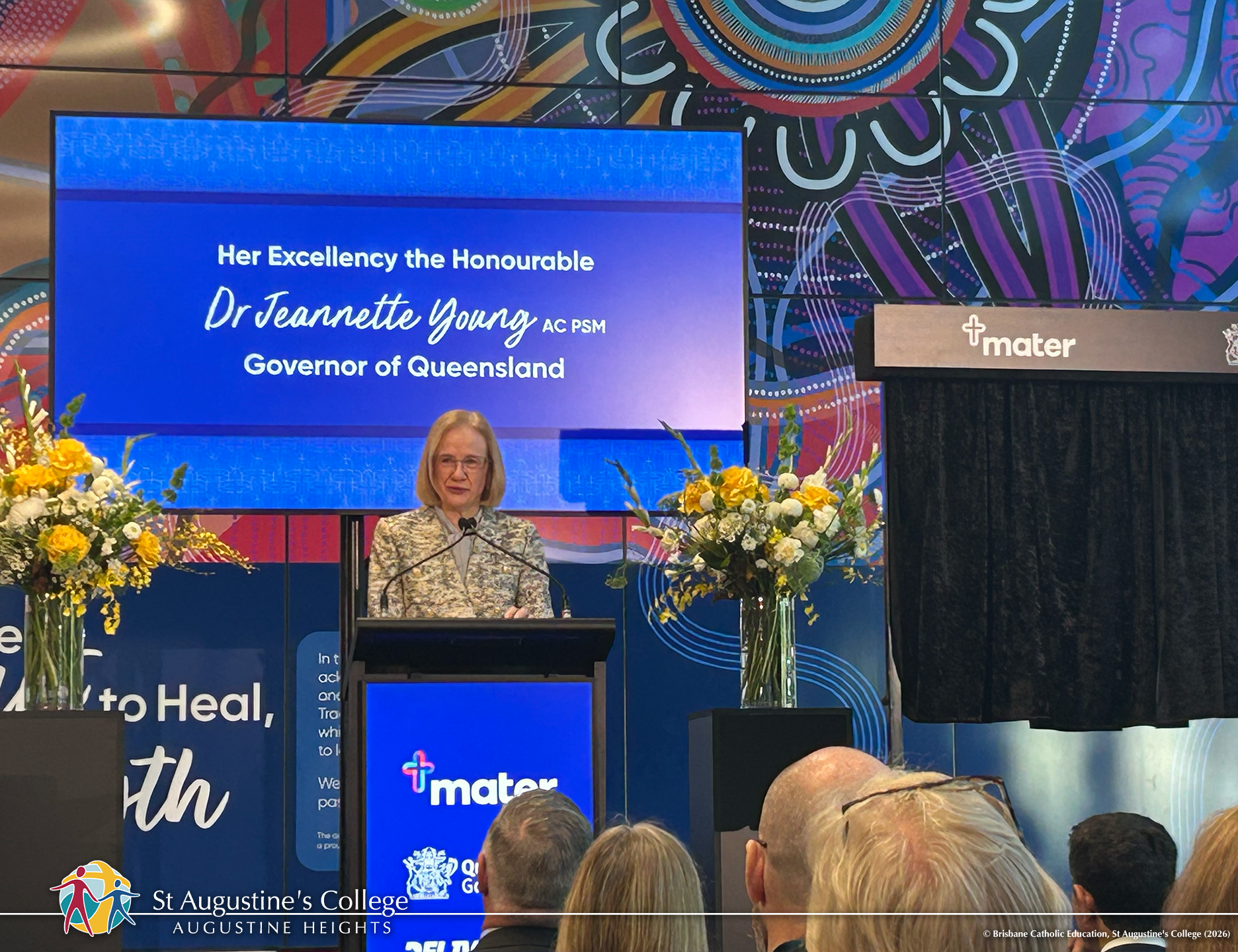 Dr Jeannette Young speaking at lectern.